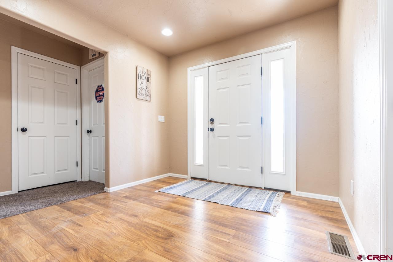 1265 H25 Road Delta, CO 81416 - Photo 6 of 34 a view of an empty room with wooden floor
