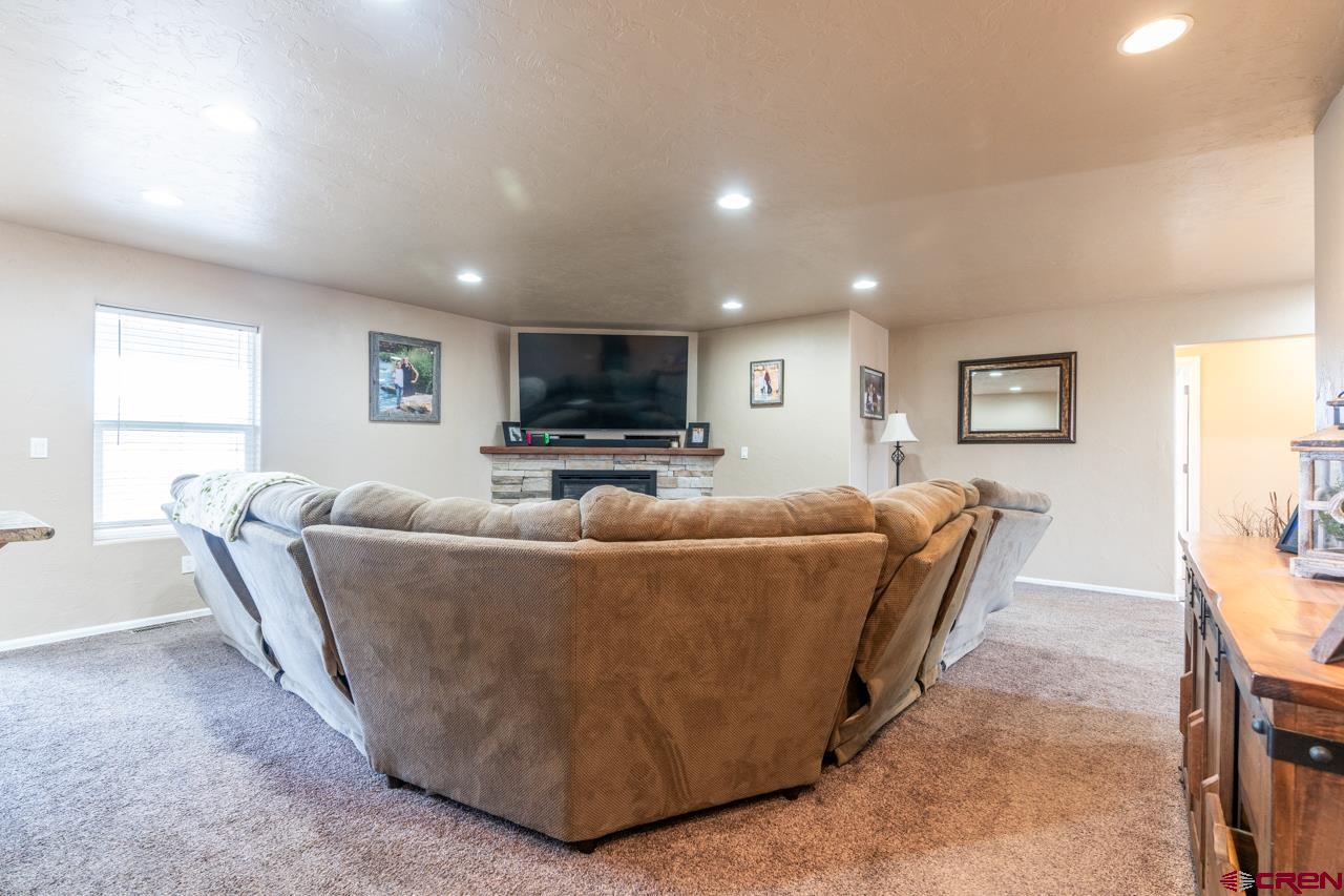 1265 H25 Road Delta, CO 81416 - Photo 9 of 34 a living room with furniture and a flat screen tv