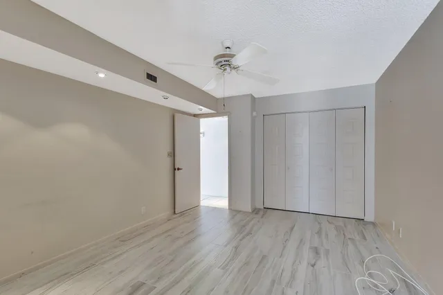 a view of a room with wooden floor and white walls