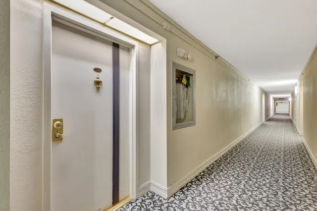 a view of hallway with wooden floor
