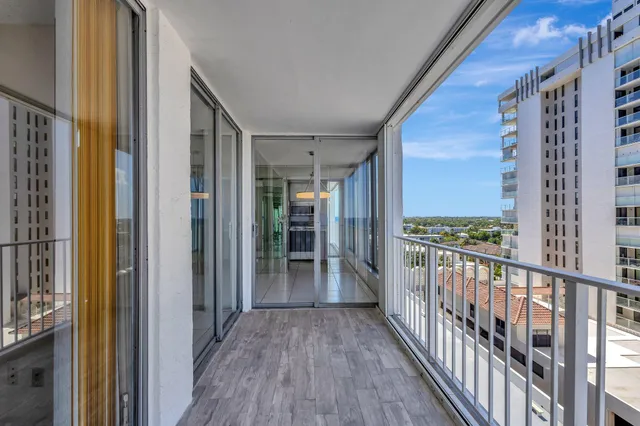 a view of a balcony with wooden floor