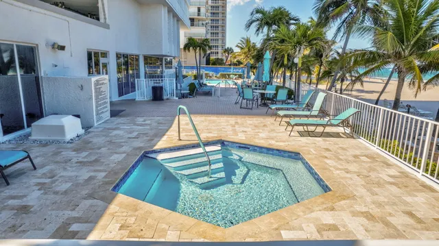 a view of a swimming pool with a chair and tables