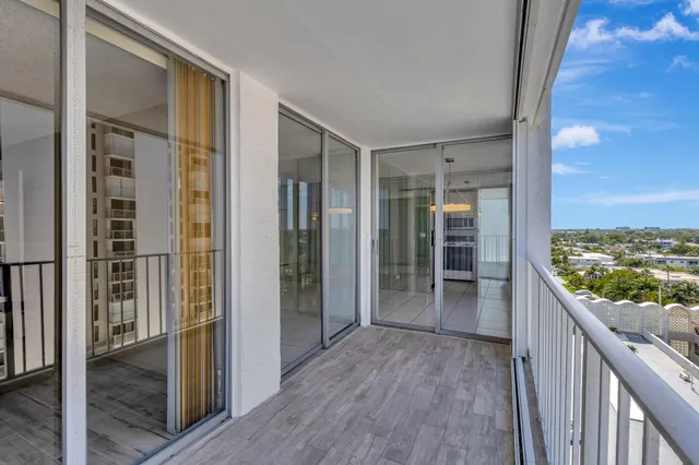 a view of balcony with floor to ceiling window and wooden floor