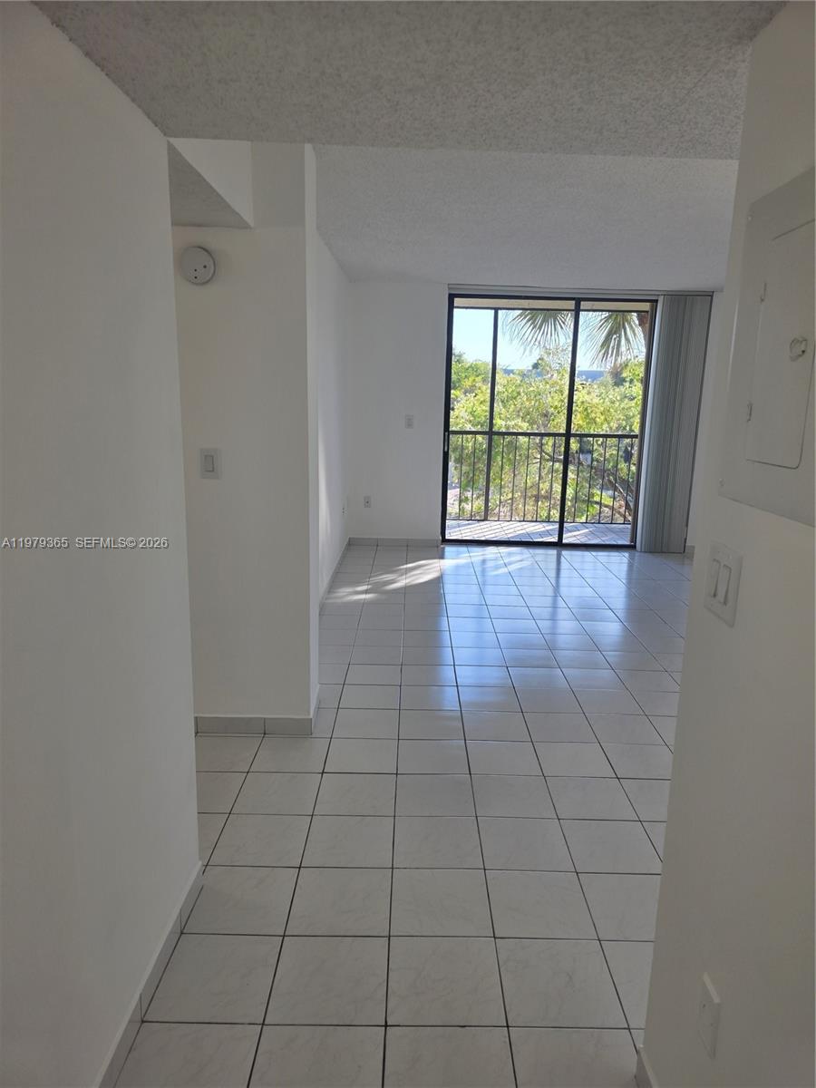 8015 Southwest 107th Avenue, Unit 313 Miami, FL 33173 - Photo 13 of 43 a view of an empty room with a window