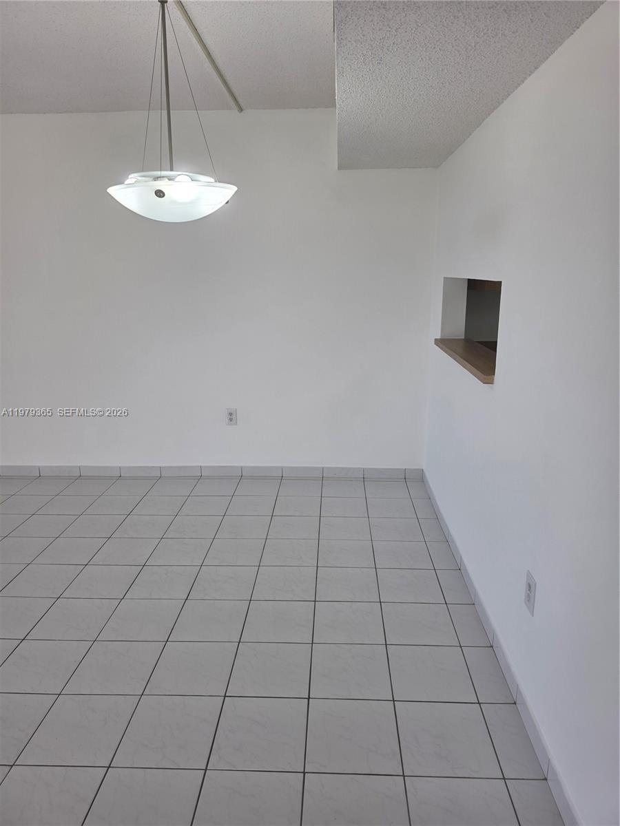 8015 Southwest 107th Avenue, Unit 313 Miami, FL 33173 - Photo 17 of 43 an empty room with a empty space and a window
