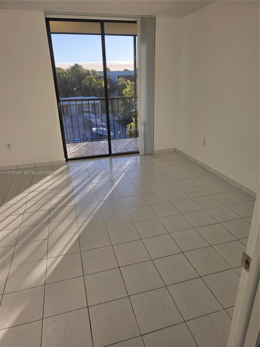 8015 Southwest 107th Avenue, Unit 313 Miami, FL 33173 - Photo 20 of 43 a view of an empty room with a window