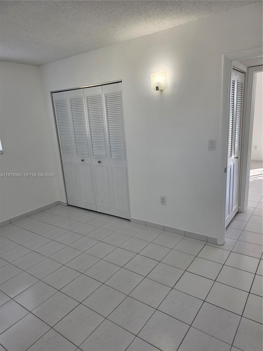 8015 Southwest 107th Avenue, Unit 313 Miami, FL 33173 - Photo 26 of 43 an empty room with an entryway