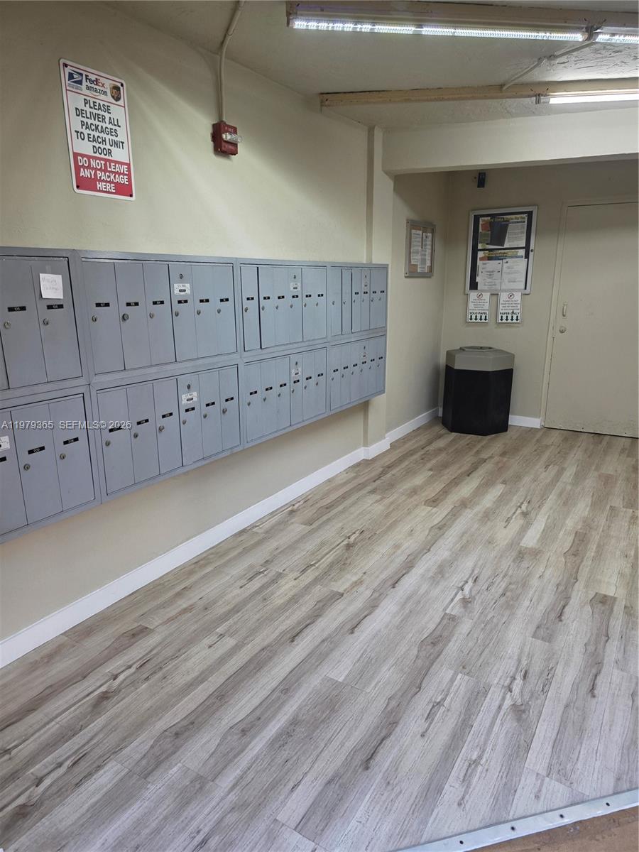 8015 Southwest 107th Avenue, Unit 313 Miami, FL 33173 - Photo 43 of 43 an empty room with wooden floor and cabinet