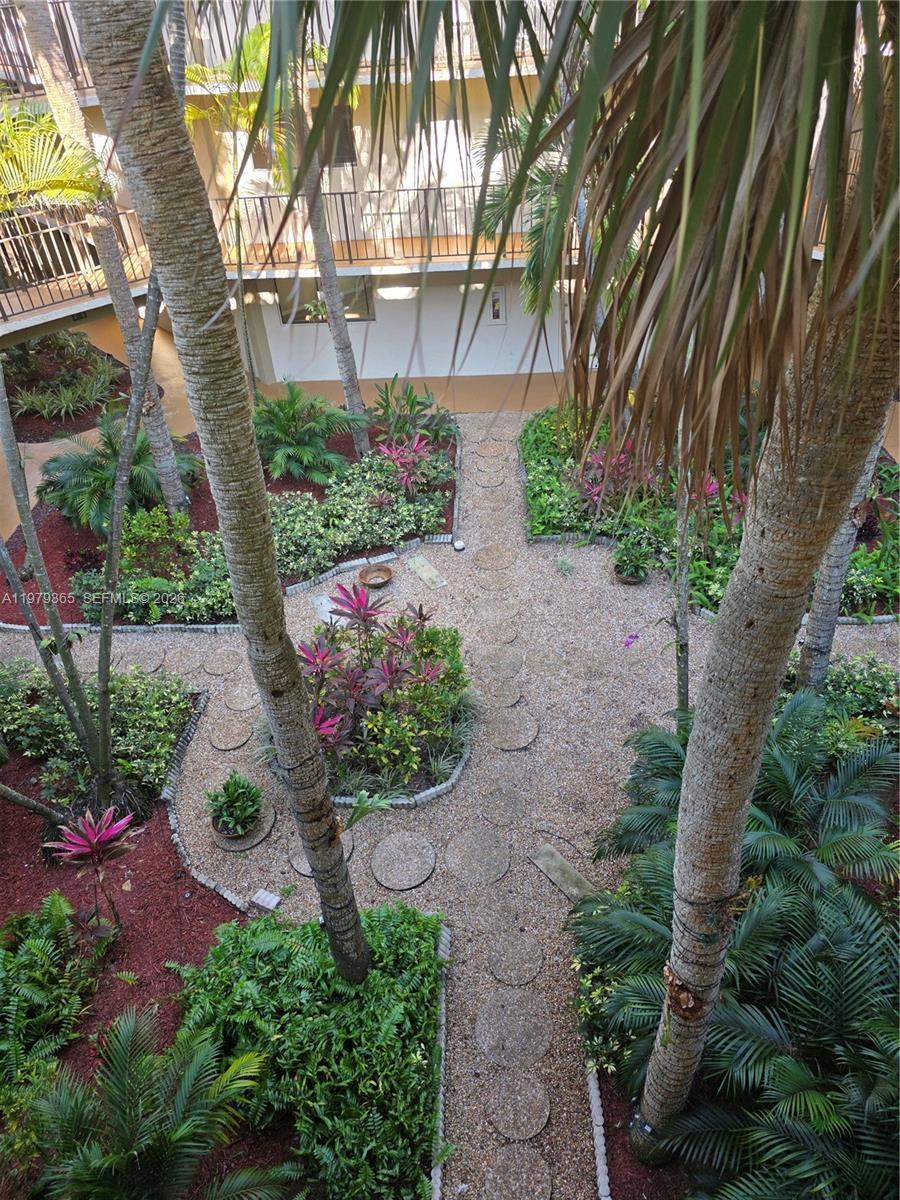 8015 Southwest 107th Avenue, Unit 313 Miami, FL 33173 - Photo 7 of 43 a view of a garden with plants and large trees