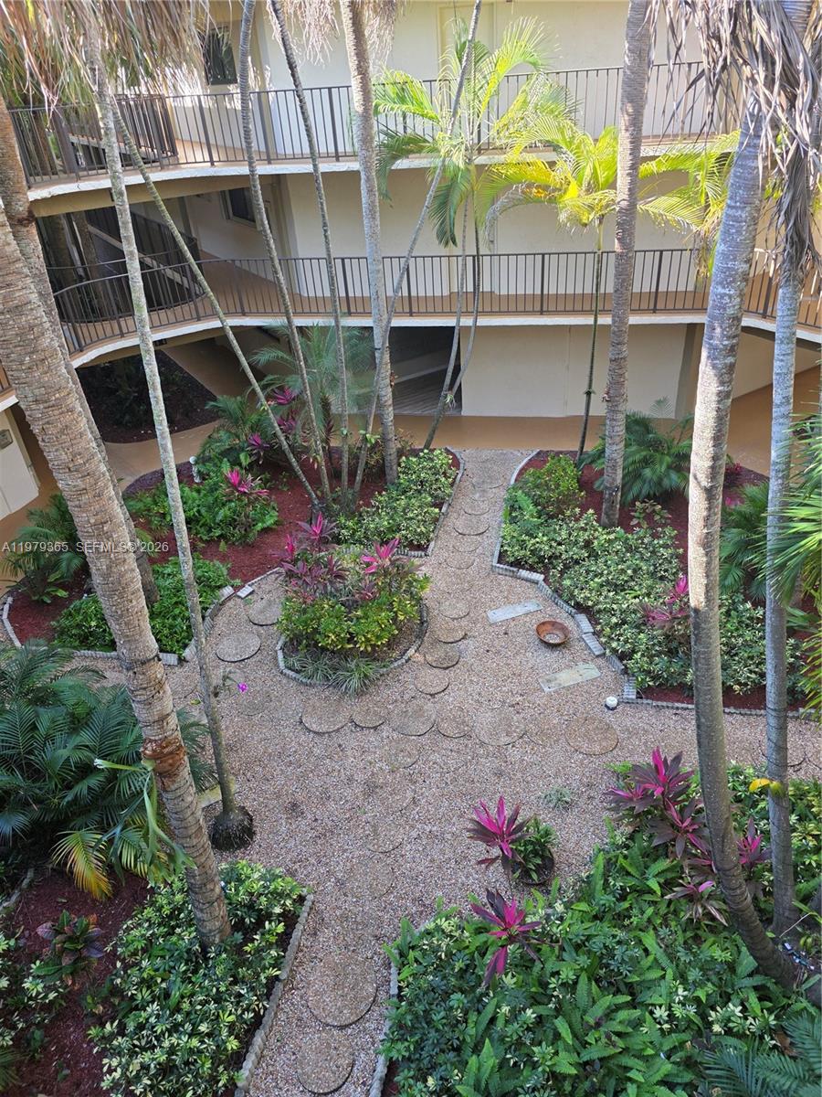 8015 Southwest 107th Avenue, Unit 313 Miami, FL 33173 - Photo 8 of 43 a flower garden is sitting in front of buildings