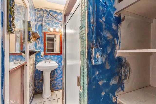 an empty room with wooden floor ceiling fan and windows