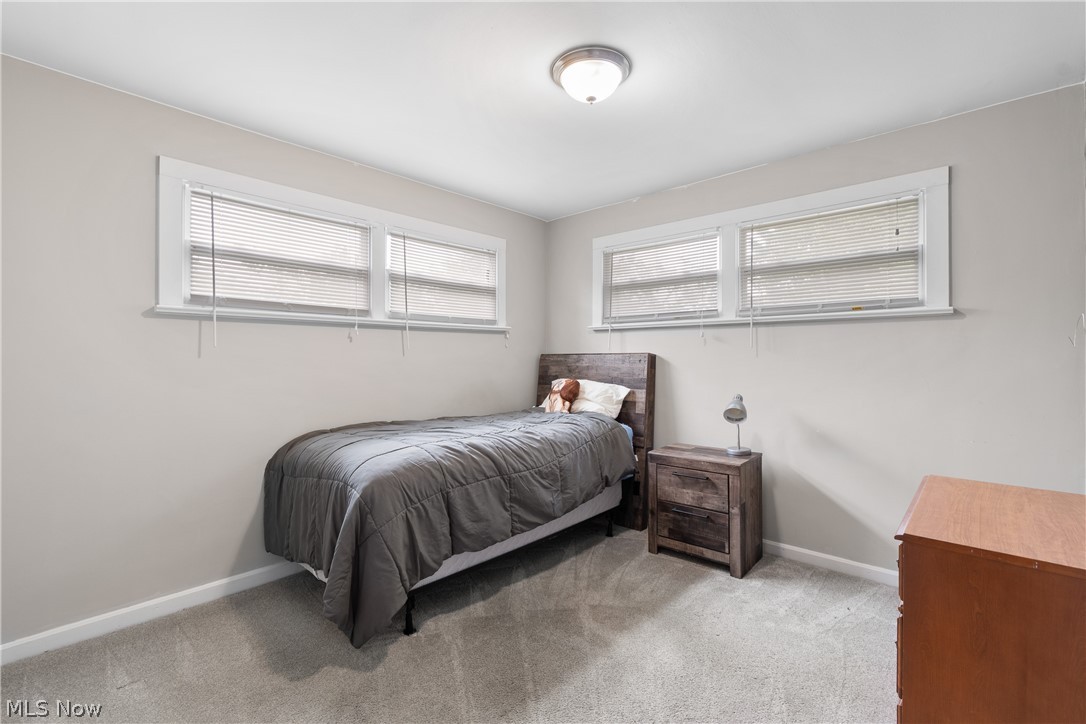 5768 Nolley Road Akron, OH 44319 - Photo 15 of 38 Nice sized bedroom with neutral painted walls white trim and grey carpeting