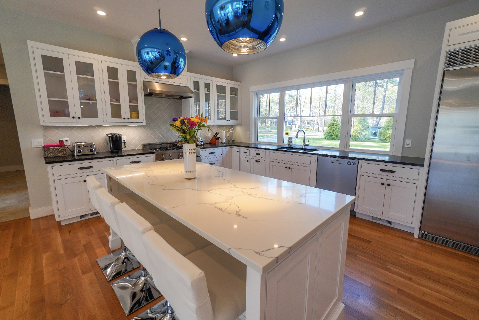 3 Sengekontacket Road Oak Bluffs, MA 02557 - Photo 11 of 34 a kitchen with a sink a counter space appliances and a window