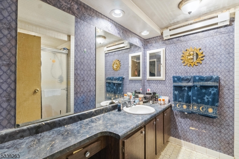 468 Liberty Street, Unit 101 Little Ferry, NJ 07643 - Photo 13 of 18 a bathroom with a granite countertop sink and a mirror