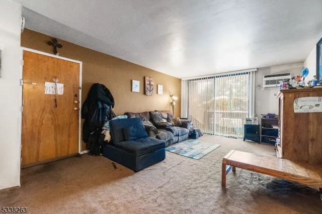 a living room with furniture a lamp and a window