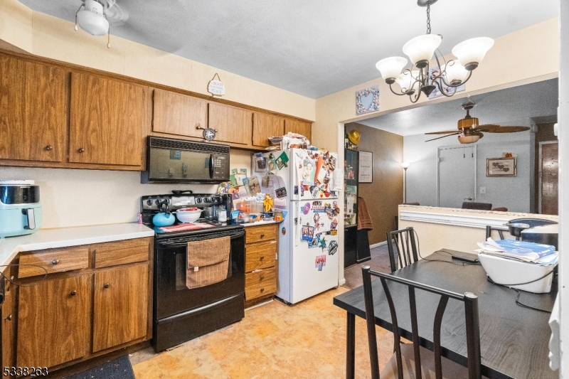 468 Liberty Street, Unit 101 Little Ferry, NJ 07643 - Photo 8 of 18 a kitchen with stainless steel appliances granite countertop a sink dishwasher stove and refrigerator with wooden floor