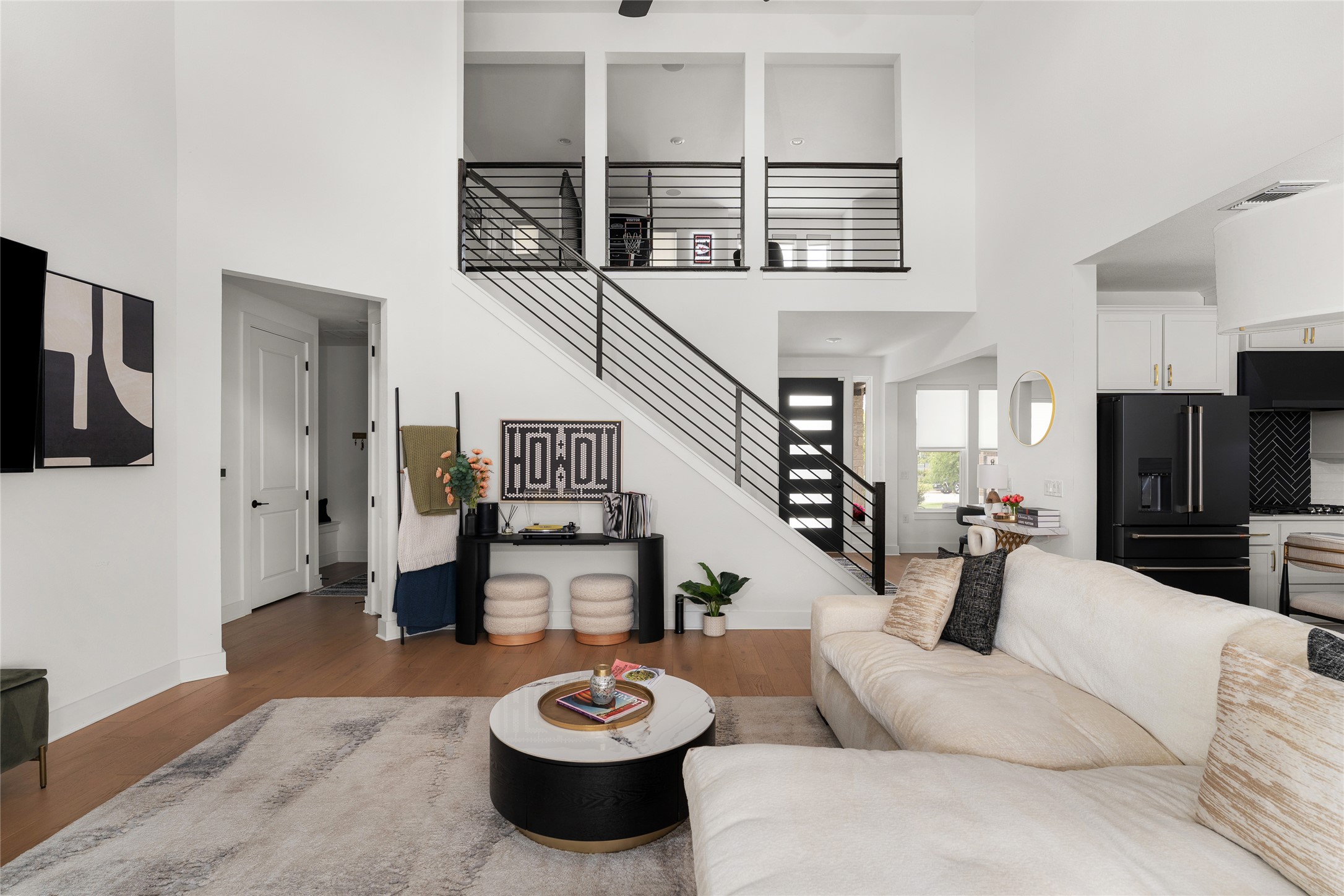 7917 Edmondson Bend Austin, TX 78744 - Photo 6 of 24 Expansive living area with soaring ceilings and wood-finish flooring