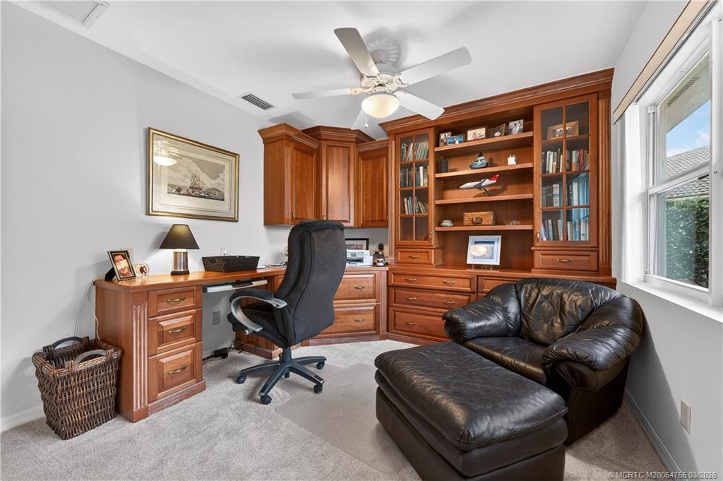 13319 Northwest Maplewood Road Palm City, FL 34990 - Photo 22 of 42 a view of a livingroom with workspace and a couch
