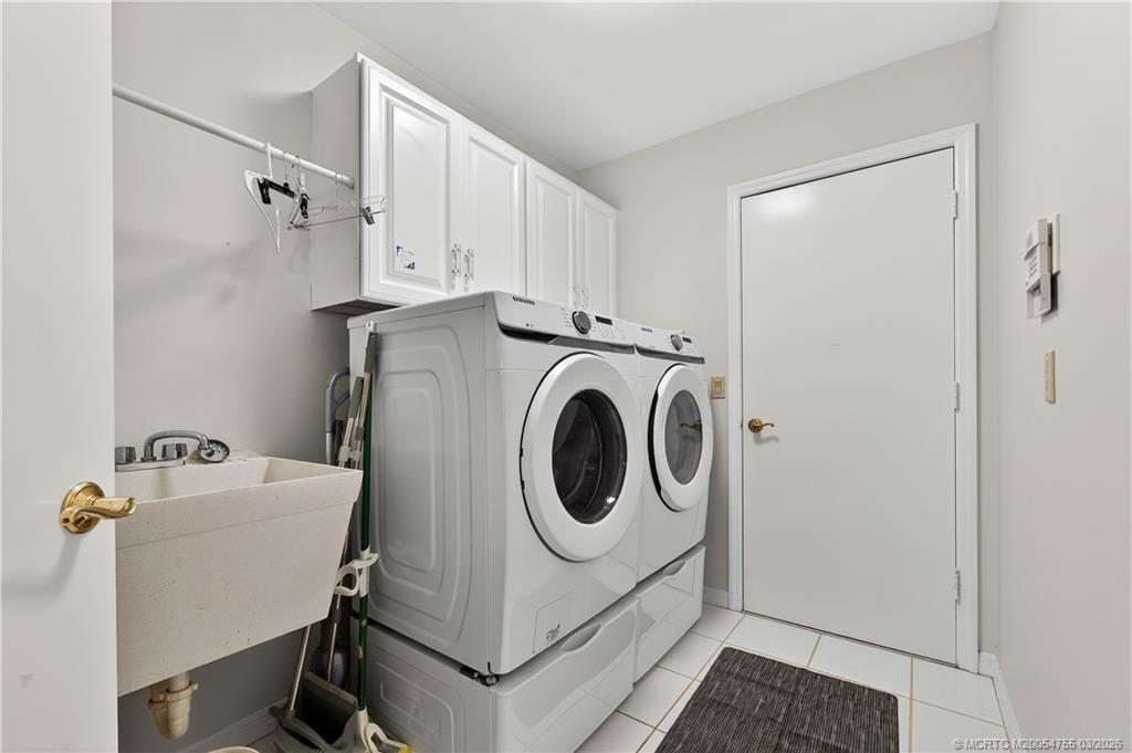 13319 Northwest Maplewood Road Palm City, FL 34990 - Photo 27 of 42 a utility room with dryer and washer