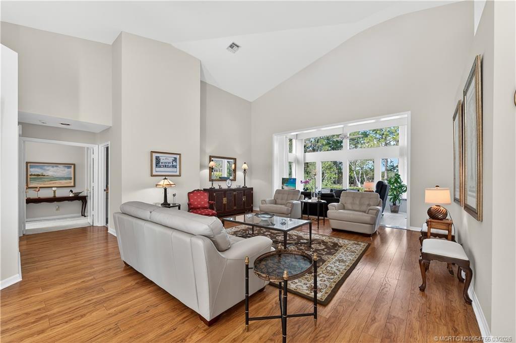 13319 Northwest Maplewood Road Palm City, FL 34990 - Photo 3 of 42 a living room with furniture and a wooden floor