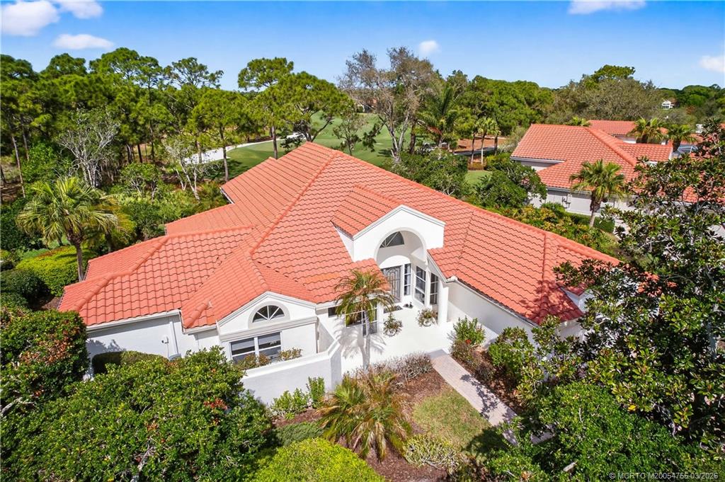 13319 Northwest Maplewood Road Palm City, FL 34990 - Photo 33 of 42 an aerial view of a house with a yard and a garden