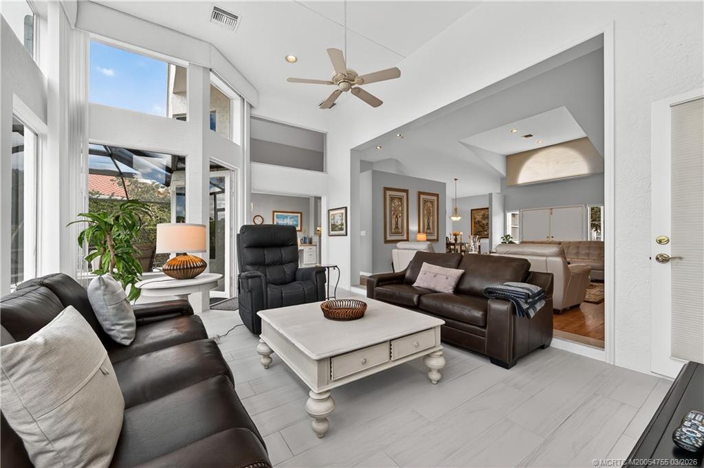 13319 Northwest Maplewood Road Palm City, FL 34990 - Photo 7 of 42 a living room with furniture and a fireplace