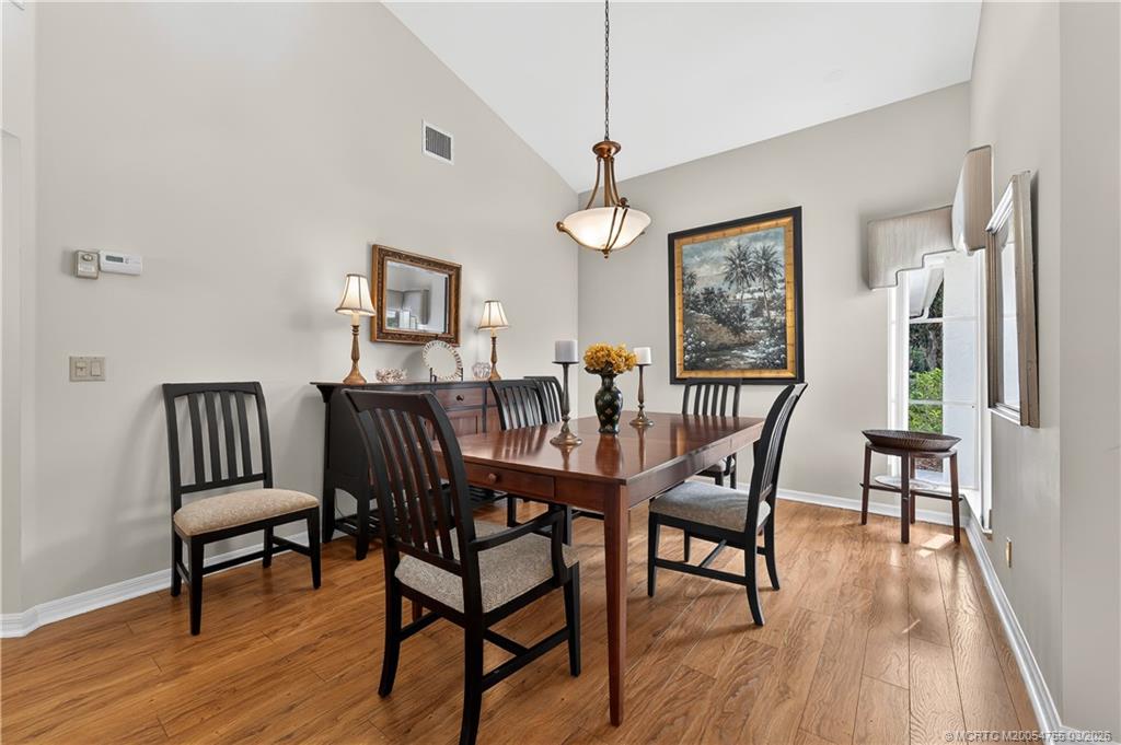 13319 Northwest Maplewood Road Palm City, FL 34990 - Photo 9 of 42 a view of a dining room with furniture window and wooden floor