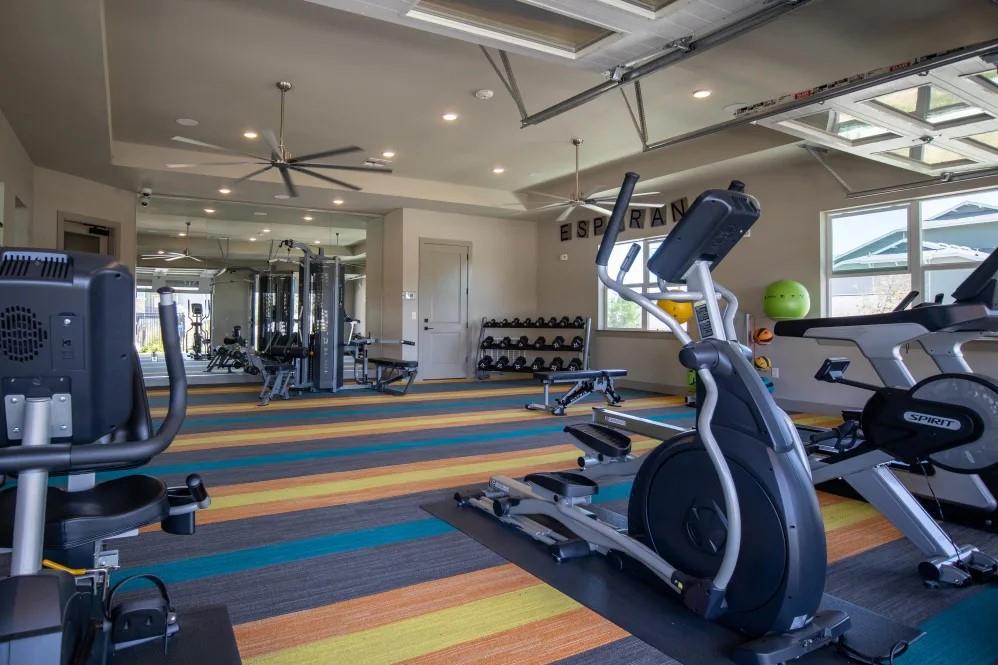 a room with gym equipment and a mirror