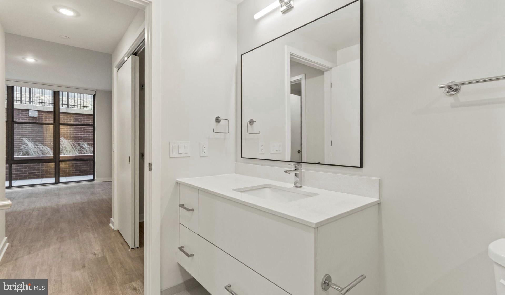 4000 Wisconsin Avenue Northwest, Unit 4K236 Washington, DC 20016 - Photo 34 of 54 a bathroom with a sink and a mirror