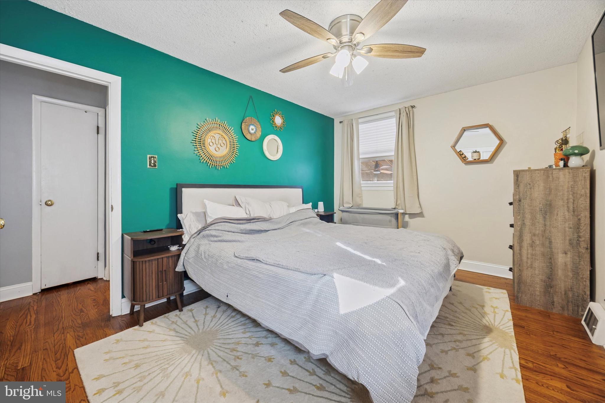 7025 Valley Avenue Philadelphia, PA 19128 - Photo 15 of 25 a bedroom with a bed and a chandelier