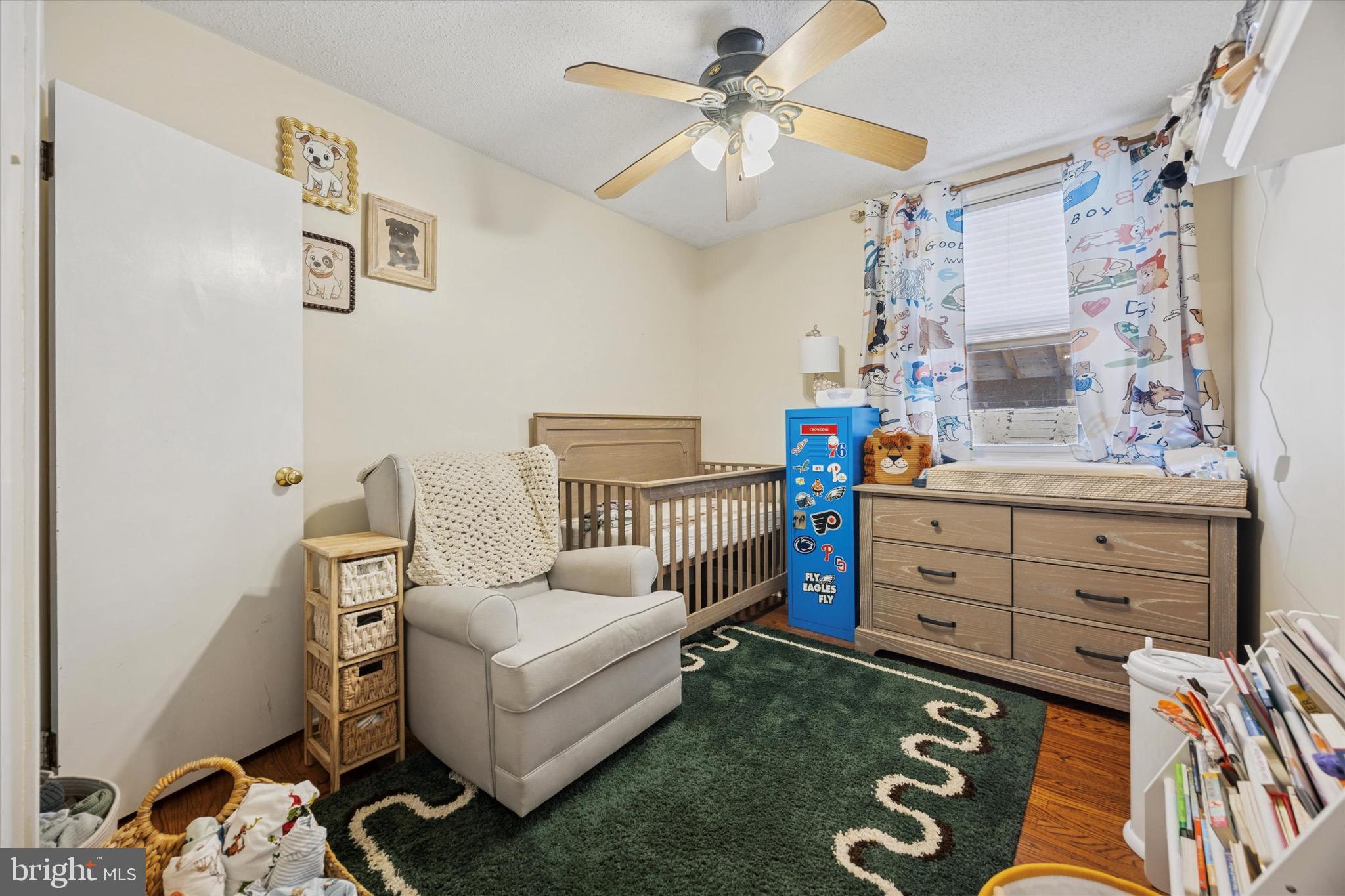 7025 Valley Avenue Philadelphia, PA 19128 - Photo 16 of 25 a bedroom with a baby bed baby crib and a dresser