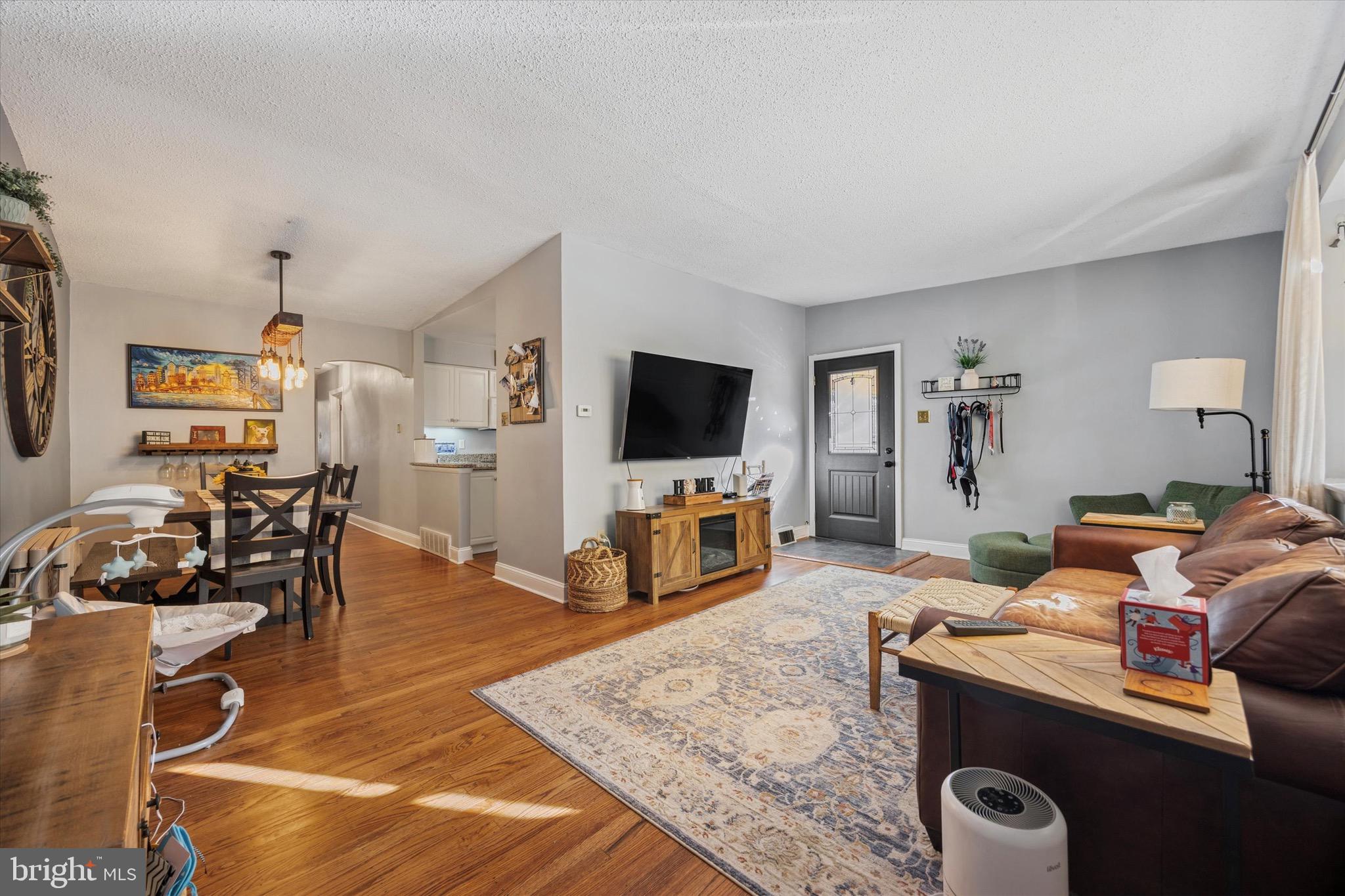 7025 Valley Avenue Philadelphia, PA 19128 - Photo 2 of 25 a living room with furniture and a flat screen tv
