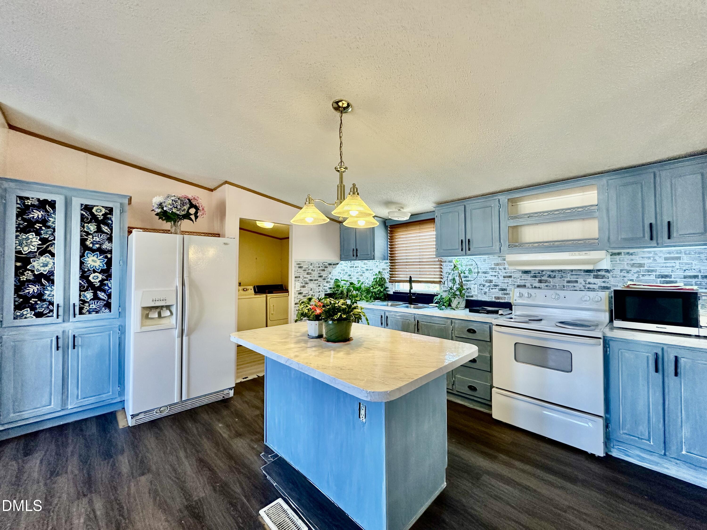 287 Oliver Loop Road Roxboro, NC 27574 - Photo 11 of 26 a kitchen with a sink cabinets and stainless steel appliances