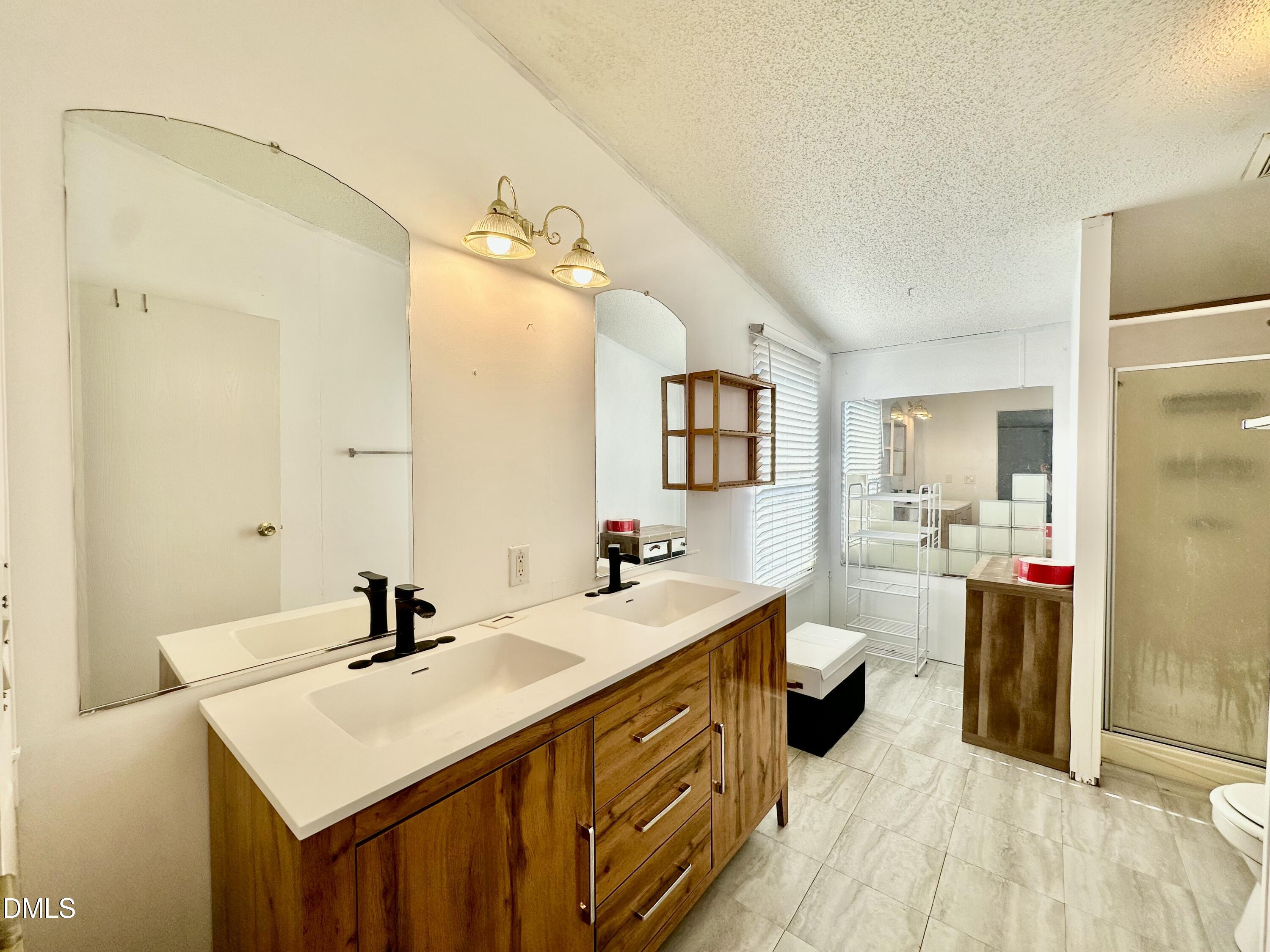 287 Oliver Loop Road Roxboro, NC 27574 - Photo 15 of 26 a bathroom with a sink double vanity and a mirror