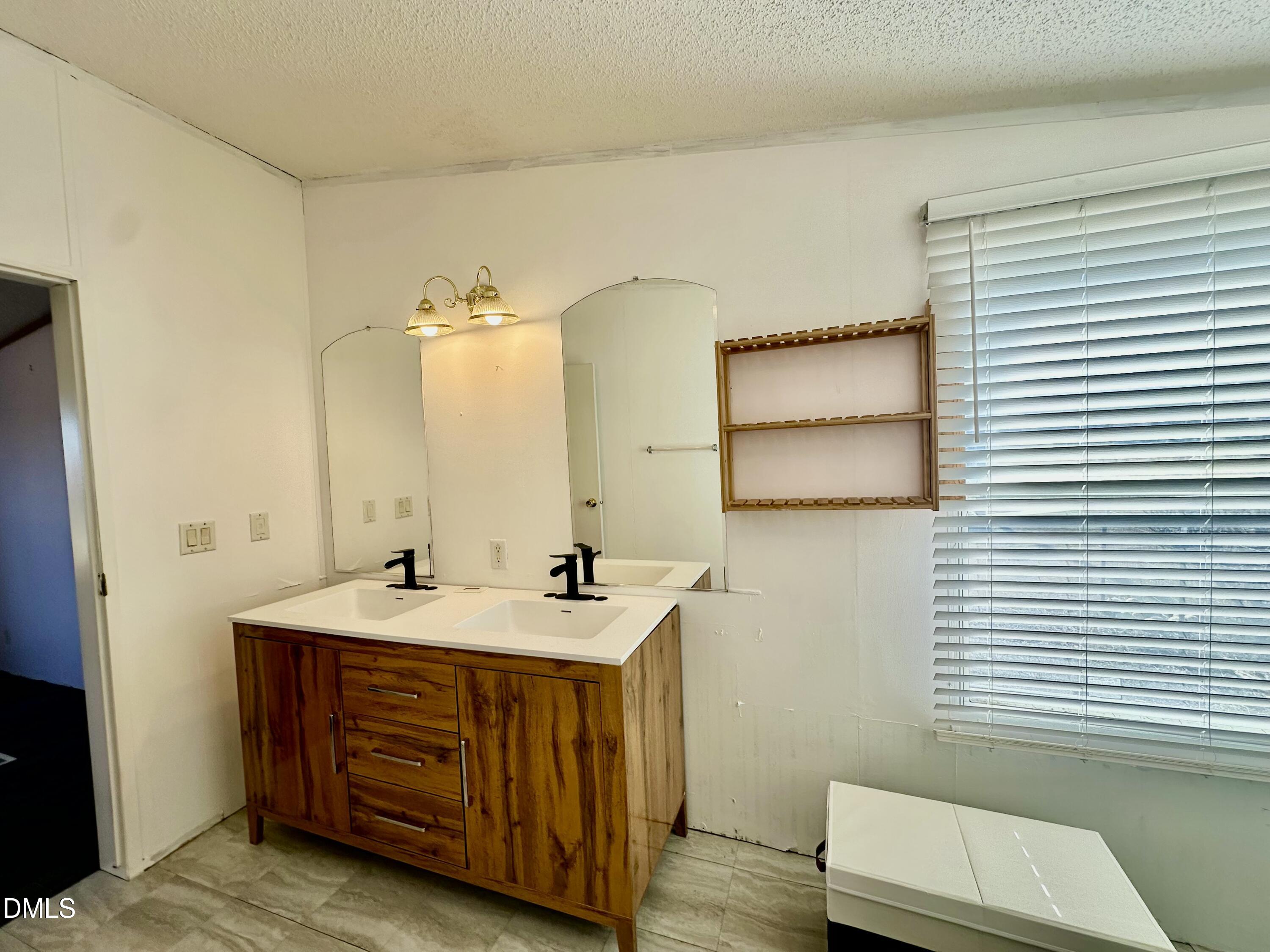 287 Oliver Loop Road Roxboro, NC 27574 - Photo 16 of 26 a bathroom with a sink and a mirror