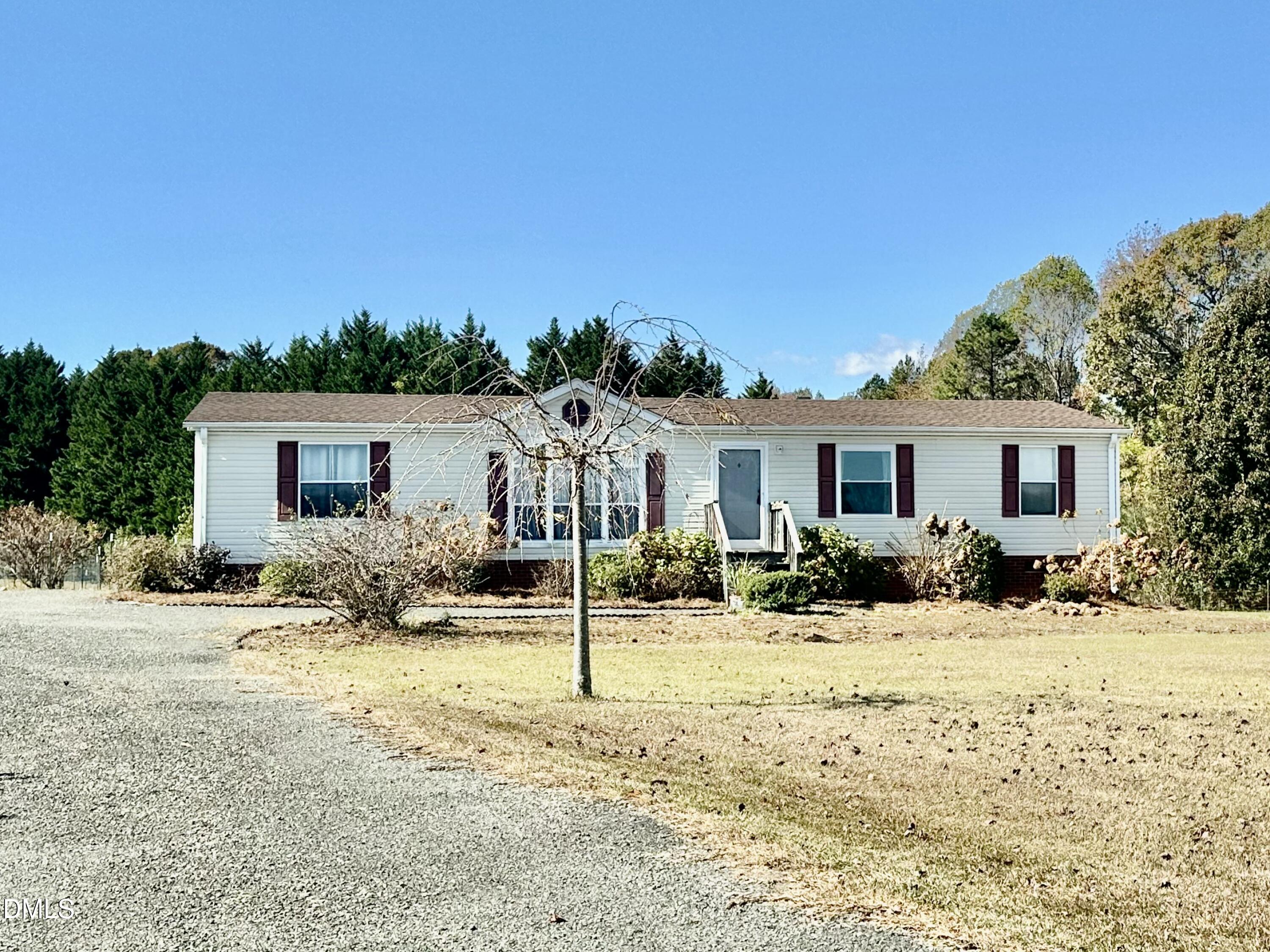 287 Oliver Loop Road Roxboro, NC 27574 - Photo 2 of 26 a view of a house with snow on the side of the road