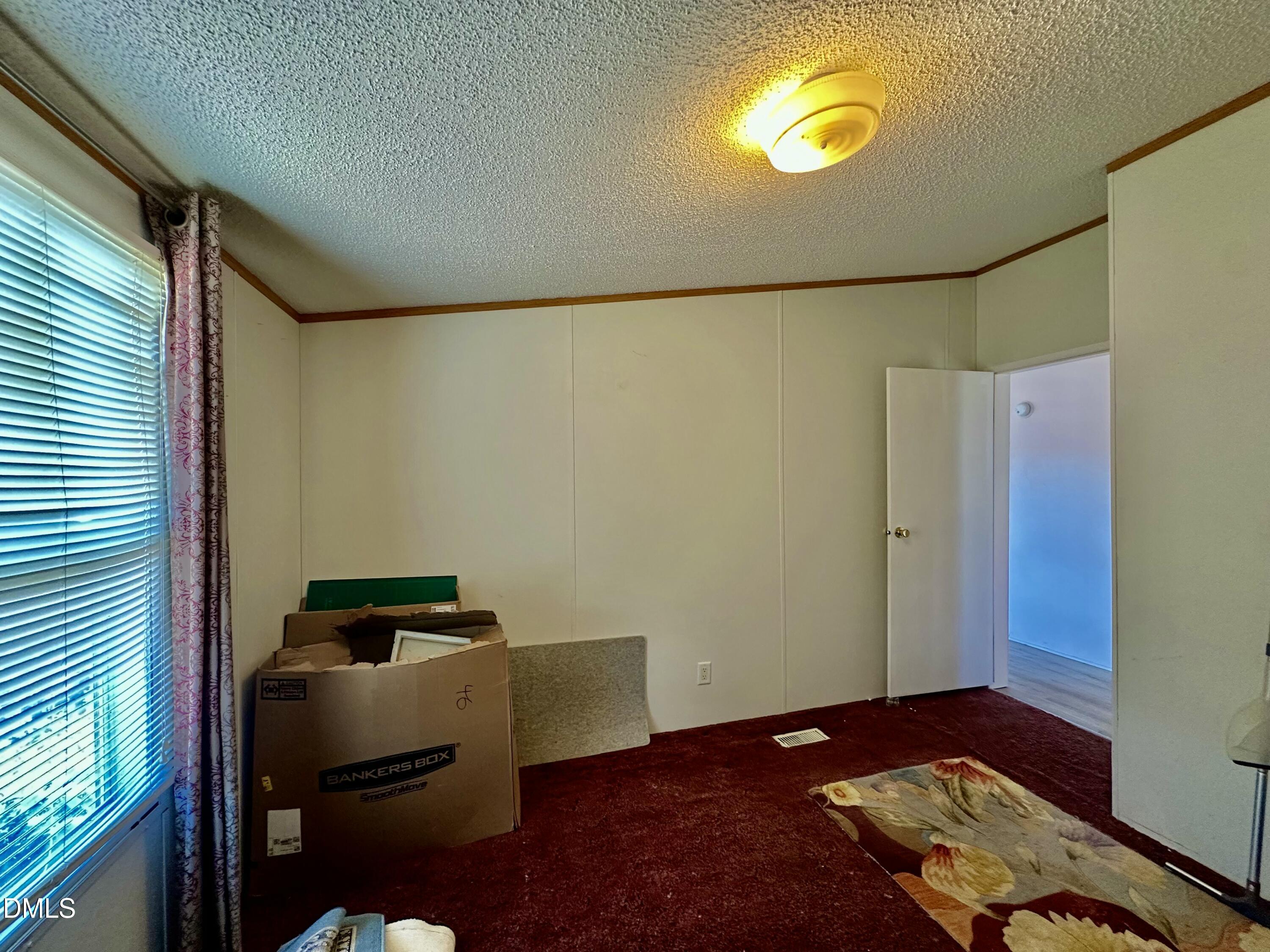 287 Oliver Loop Road Roxboro, NC 27574 - Photo 21 of 26 a bedroom with a bed and a window