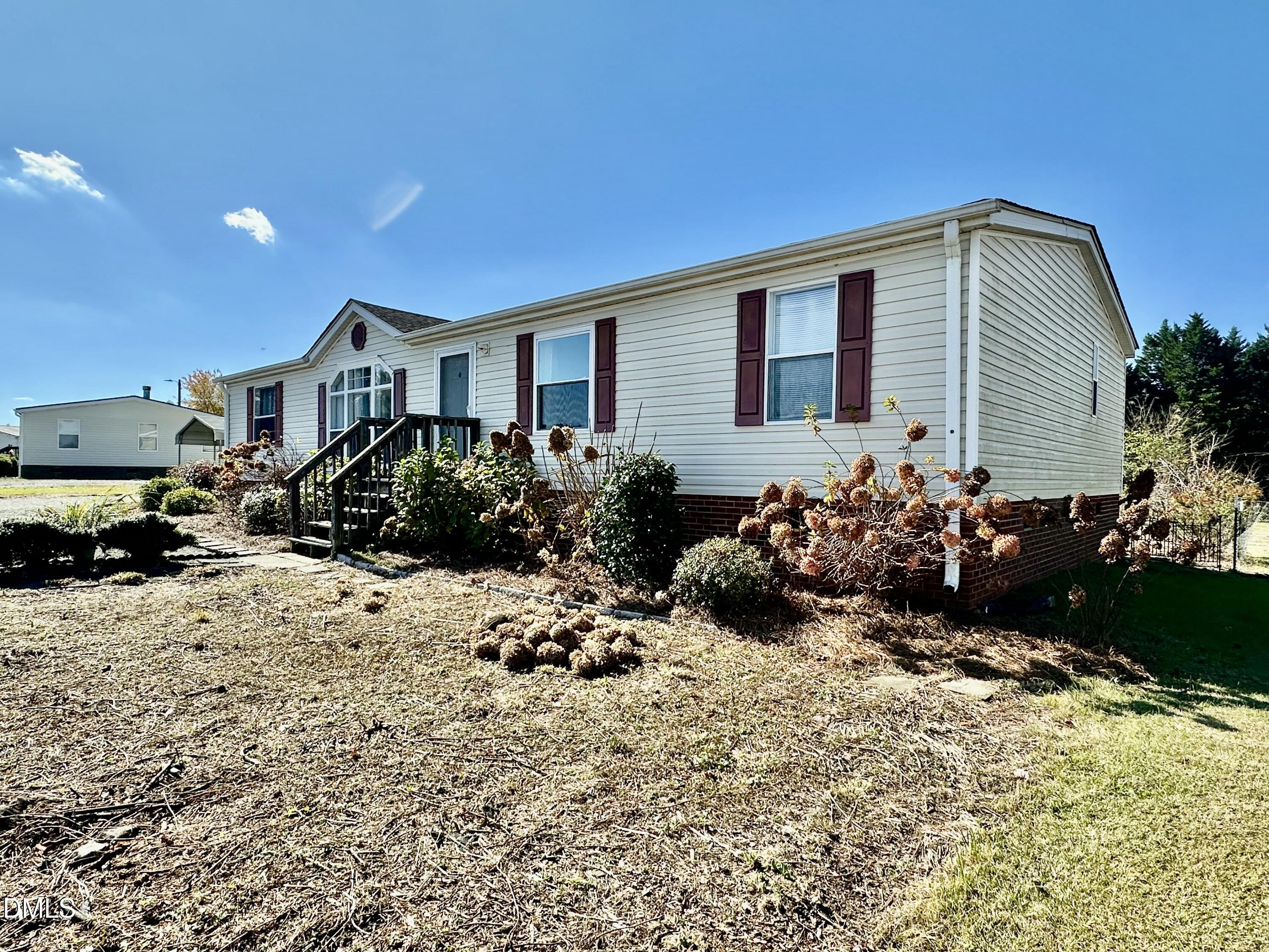 287 Oliver Loop Road Roxboro, NC 27574 - Photo 25 of 26 a front view of a house with a yard