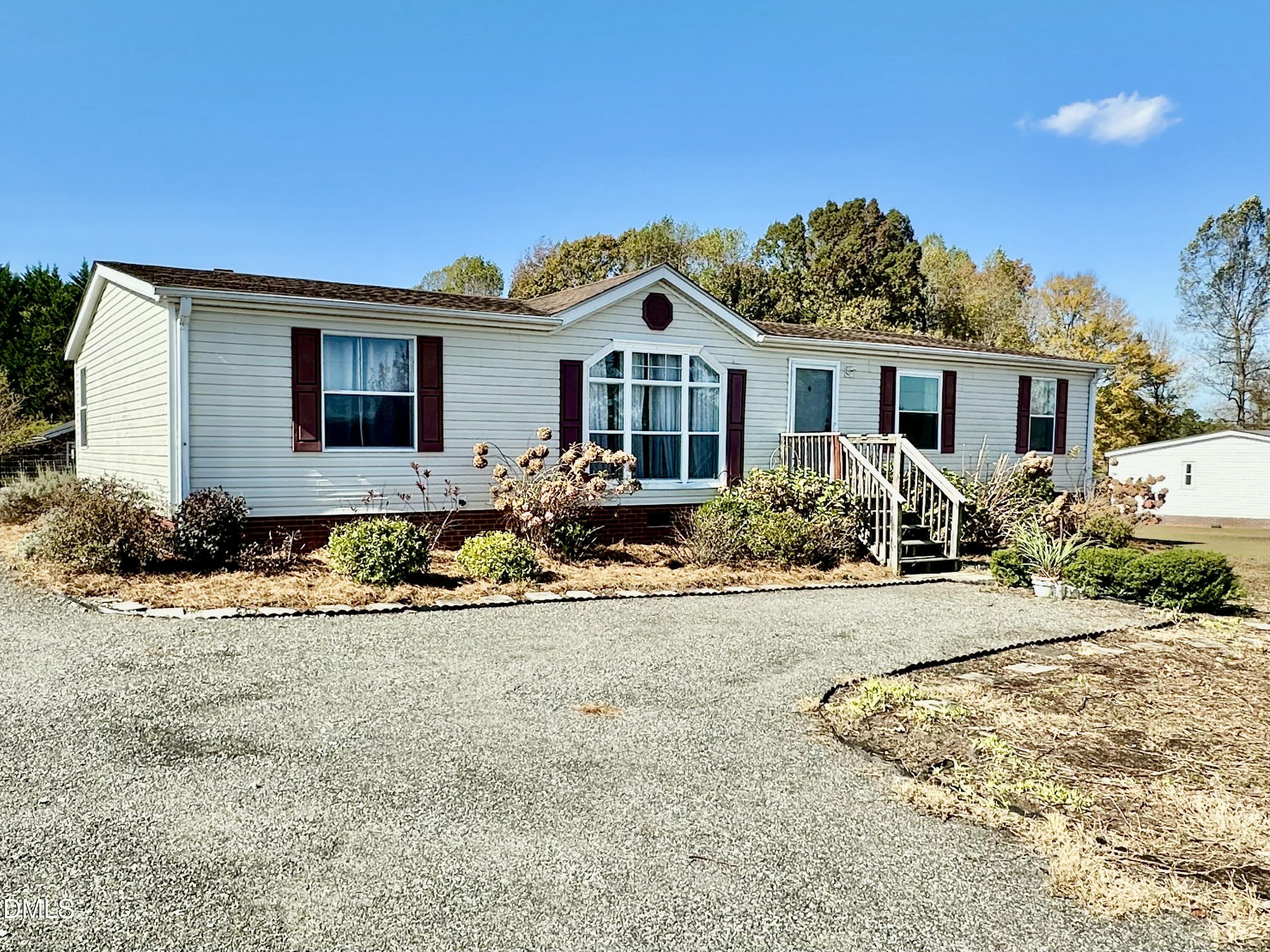 287 Oliver Loop Road Roxboro, NC 27574 - Photo 3 of 26 a front view of a house with a yard