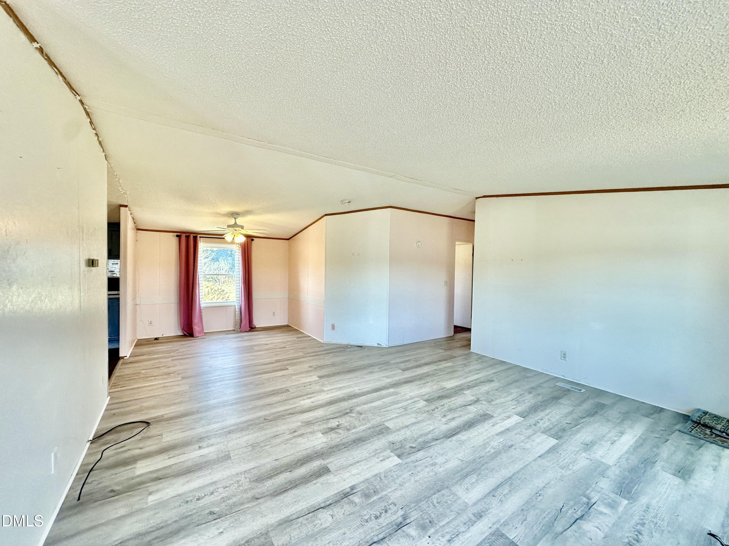 287 Oliver Loop Road Roxboro, NC 27574 - Photo 4 of 26 a view of an empty room with a window