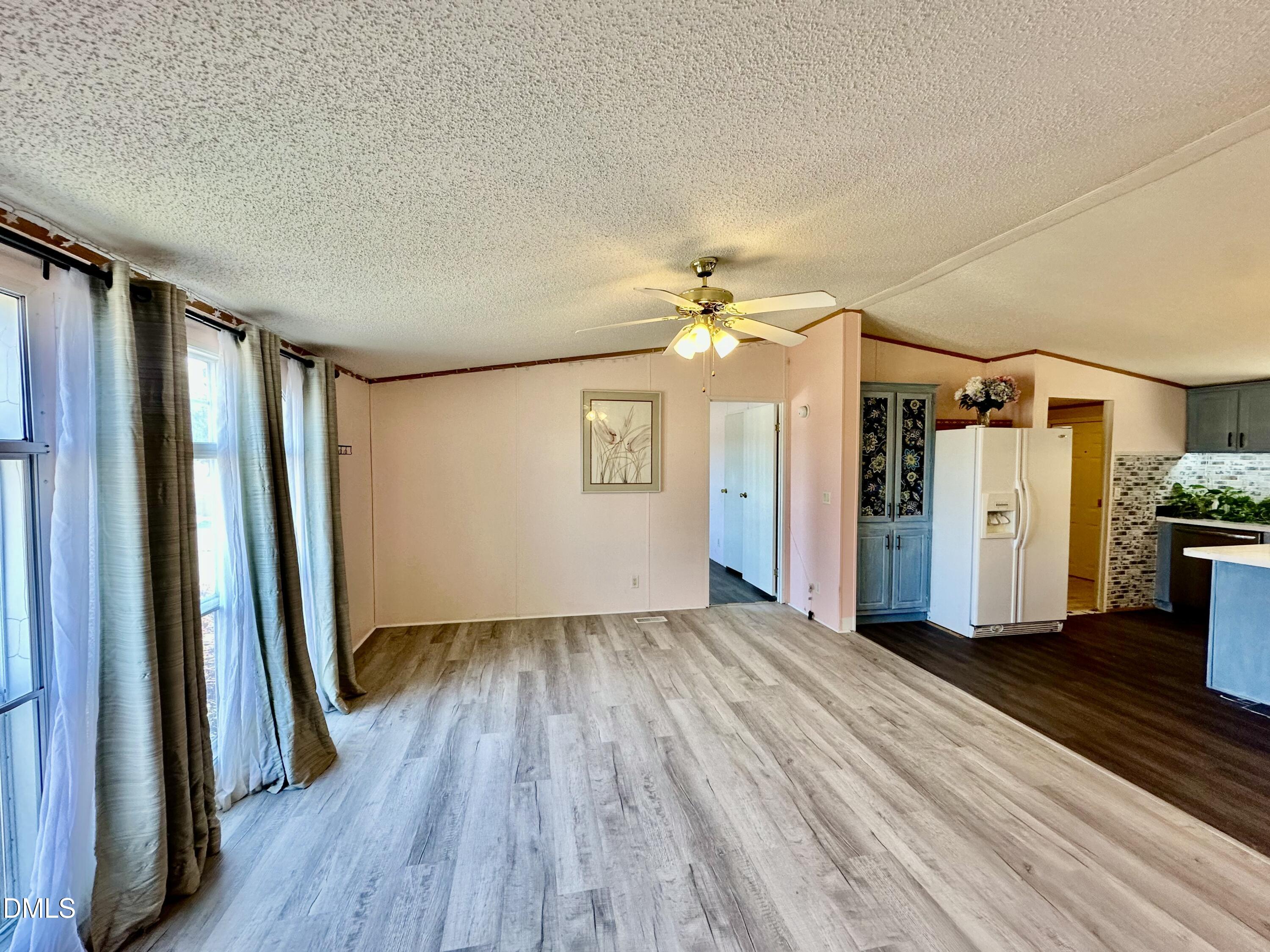 287 Oliver Loop Road Roxboro, NC 27574 - Photo 6 of 26 wooden floor in an empty room with a window