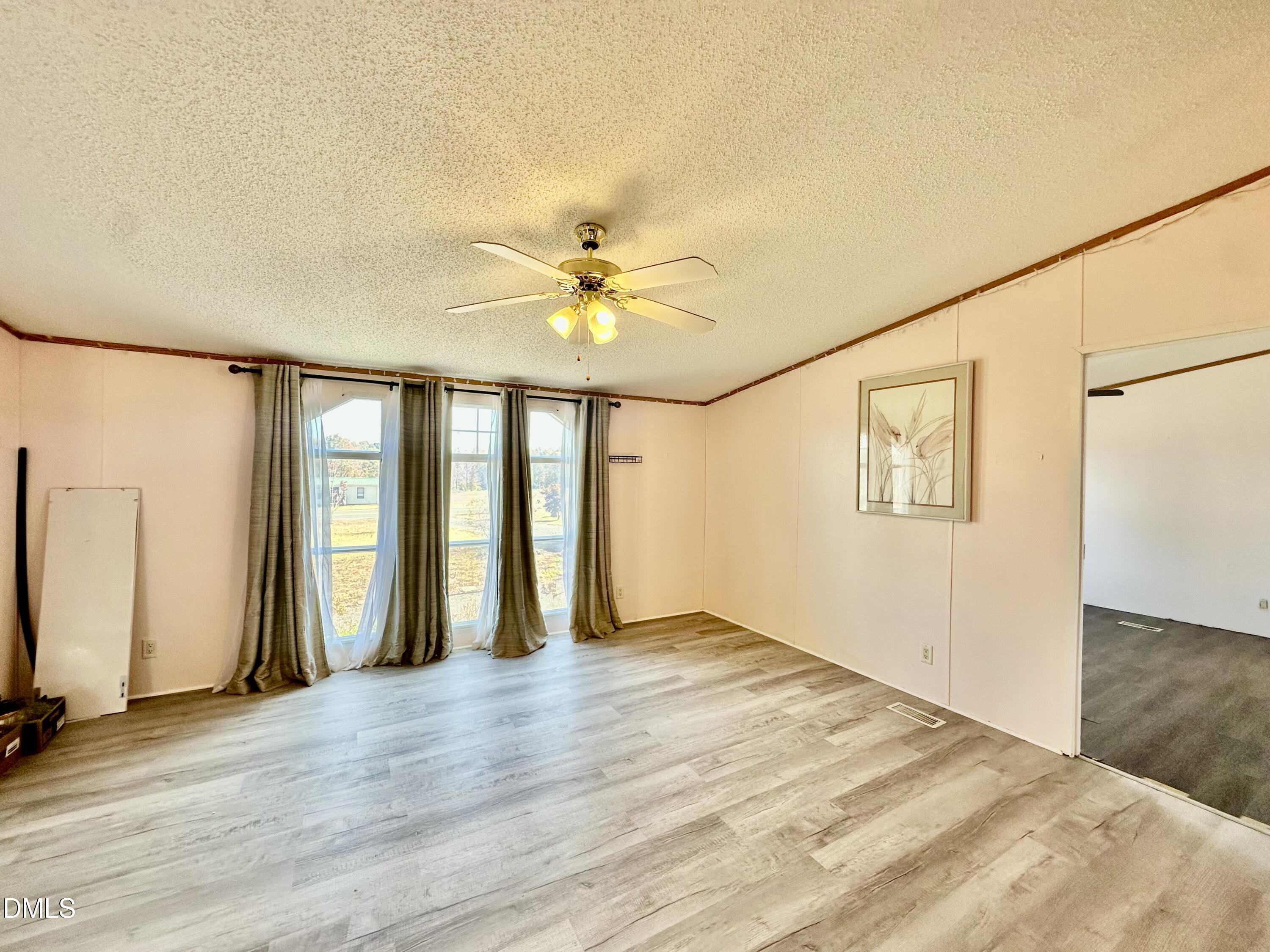 287 Oliver Loop Road Roxboro, NC 27574 - Photo 7 of 26 a view of an empty room with a window
