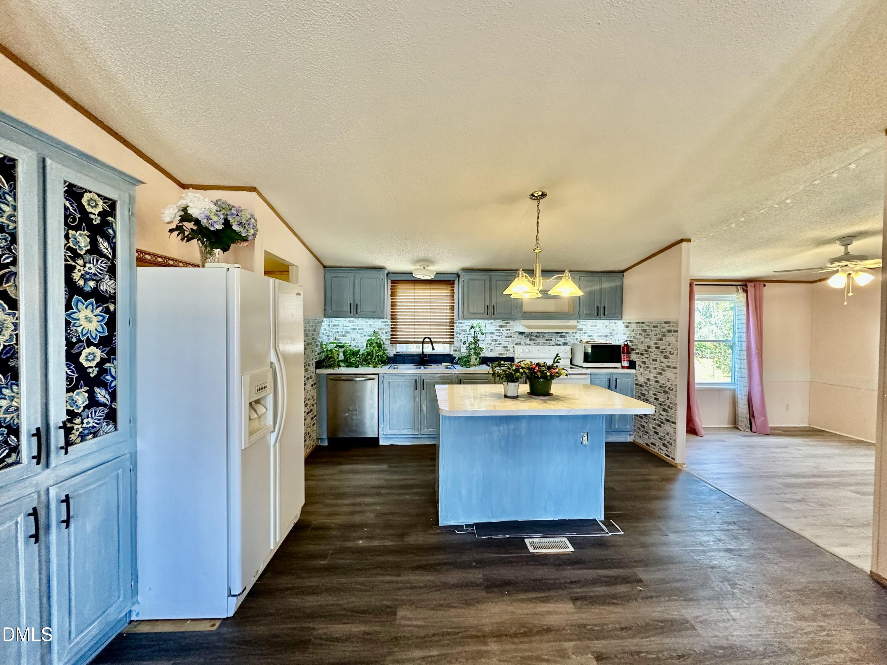 287 Oliver Loop Road Roxboro, NC 27574 - Photo 8 of 26 a kitchen with stainless steel appliances granite countertop a refrigerator a oven a stove and a wooden floors