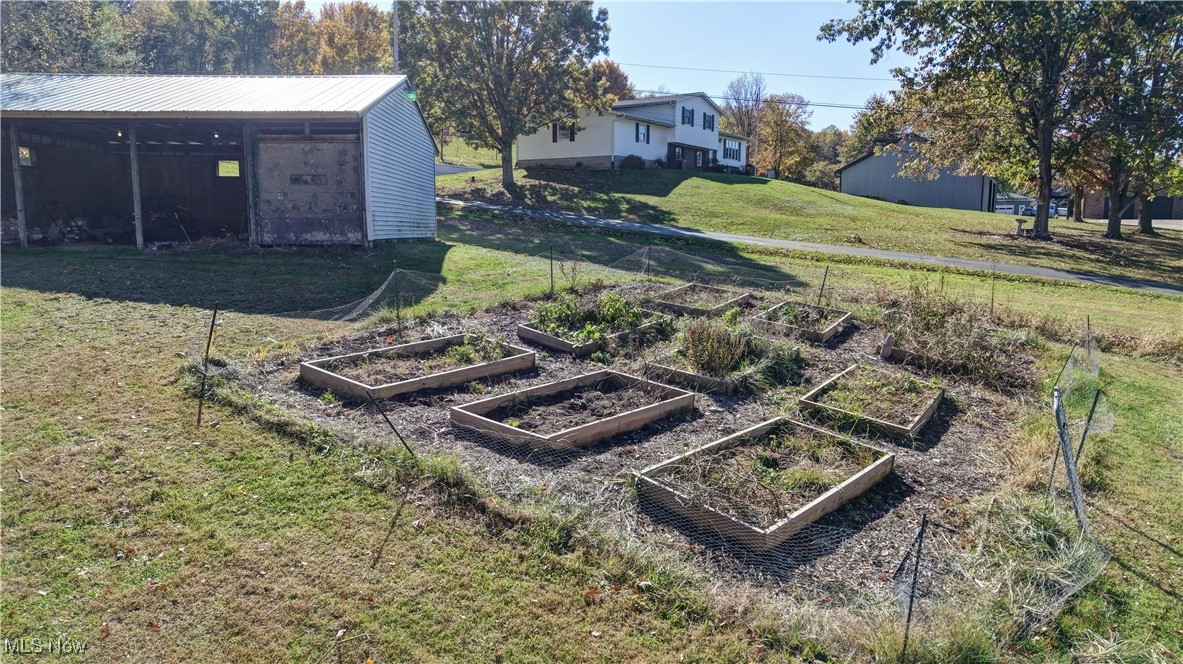 4244 Murray Road Dover, OH 44622 - Photo 25 of 29 View of green lawn featuring a vegetable garden and an outdoor structure