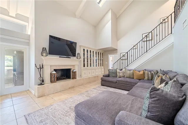 a living room with furniture a fireplace and a flat screen tv