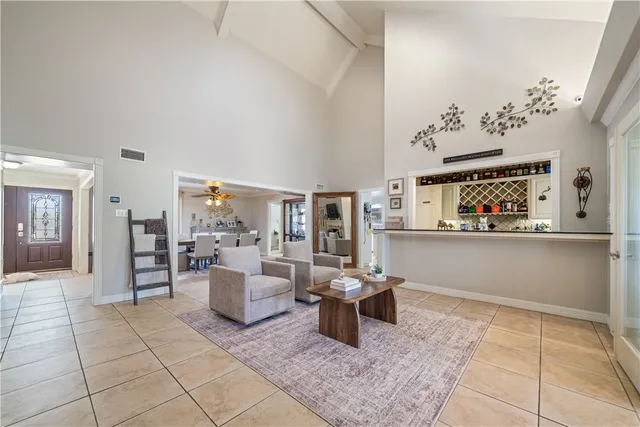 a living room with furniture and a painting on the wall