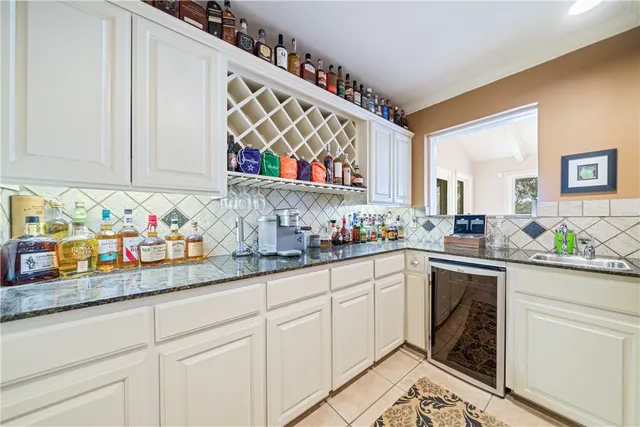 a kitchen with stainless steel appliances granite countertop a sink and cabinets