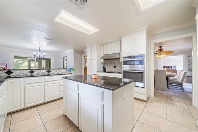 a kitchen with stainless steel appliances granite countertop a sink and cabinets