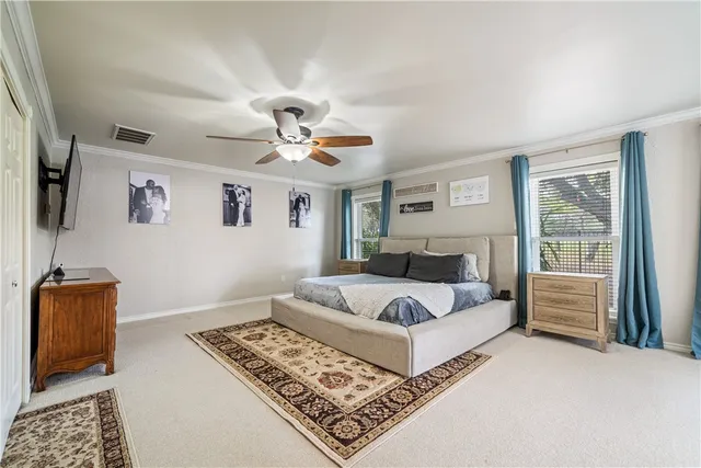 a bedroom with a large bed and a window