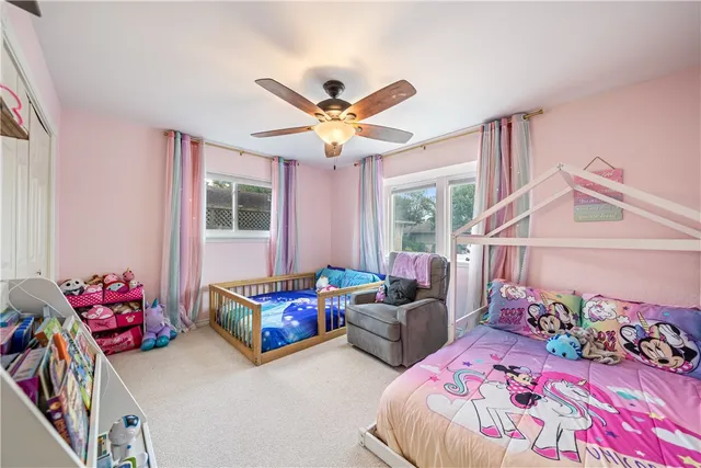 a bedroom with bed and a chandelier